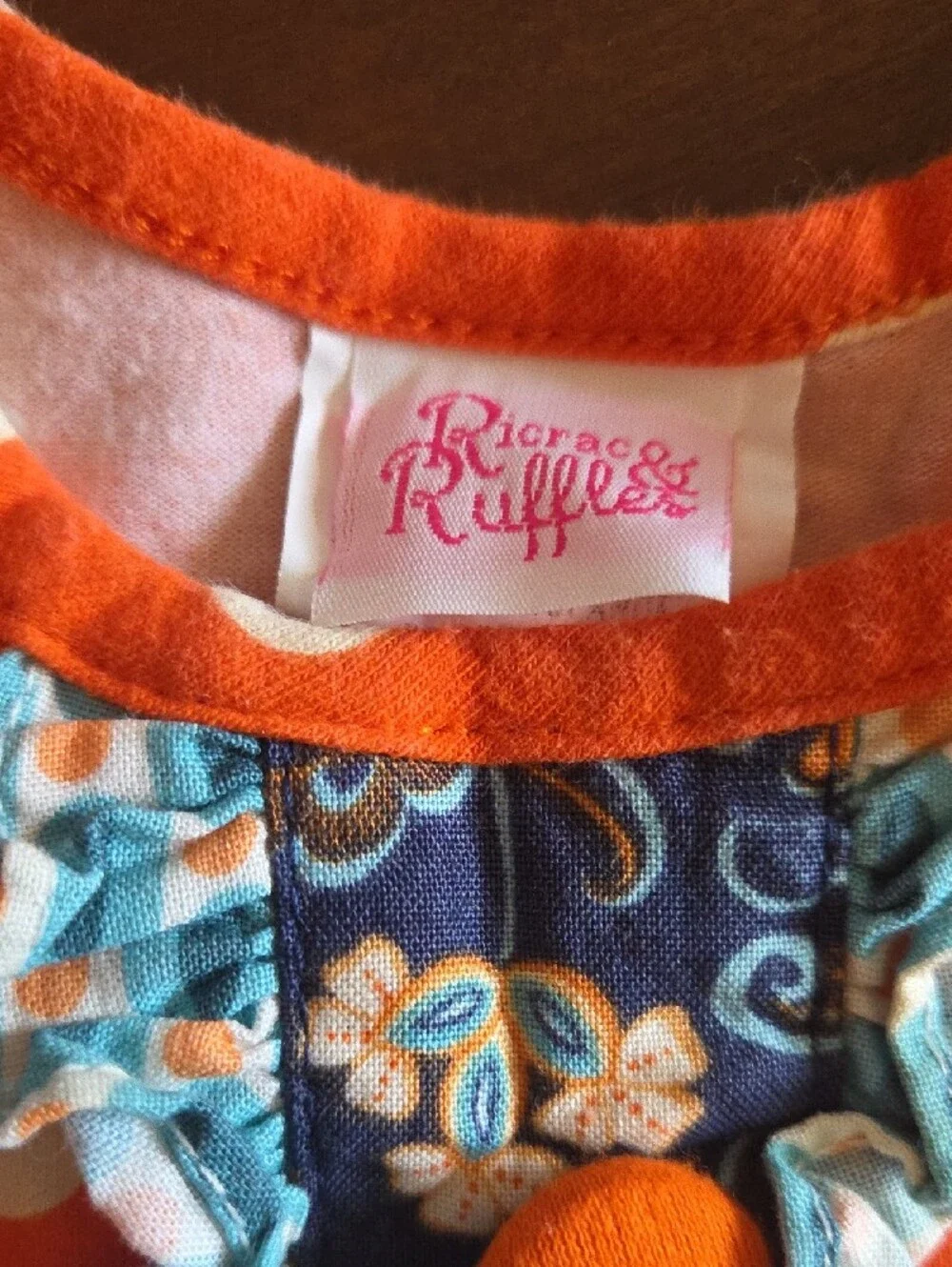 Girls Orange Polka Dot Ruffle One-Piece Bodysuit with Blue Floral Trim